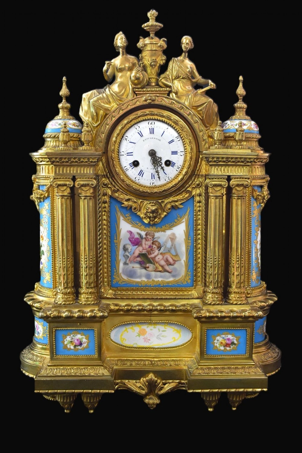 A French Napoleon III period ormolu mantel clock featuring hand-painted blue porcelain panels, classical female figures, twin fluted columns, and an enamelled dial.
