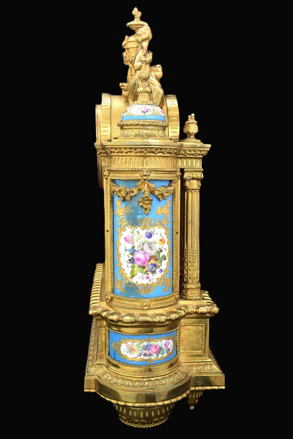 A French Napoleon III period ormolu mantel clock featuring hand-painted blue porcelain panels, classical female figures, twin fluted columns, and an enamelled dial. View III