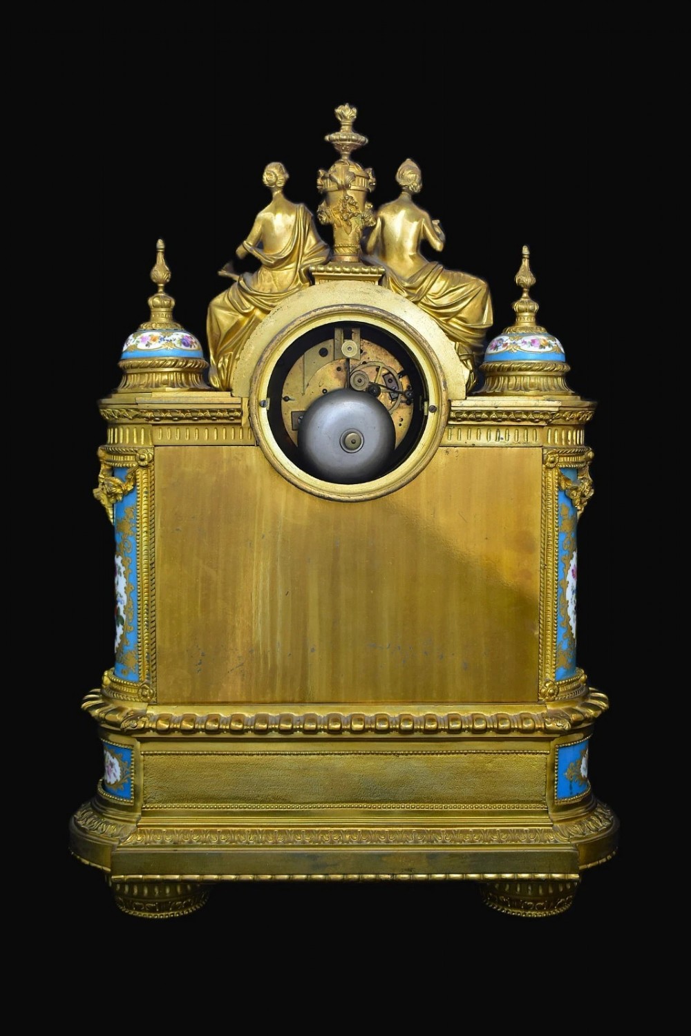 A French Napoleon III period ormolu mantel clock featuring hand-painted blue porcelain panels, classical female figures, twin fluted columns, and an enamelled dial. View IV