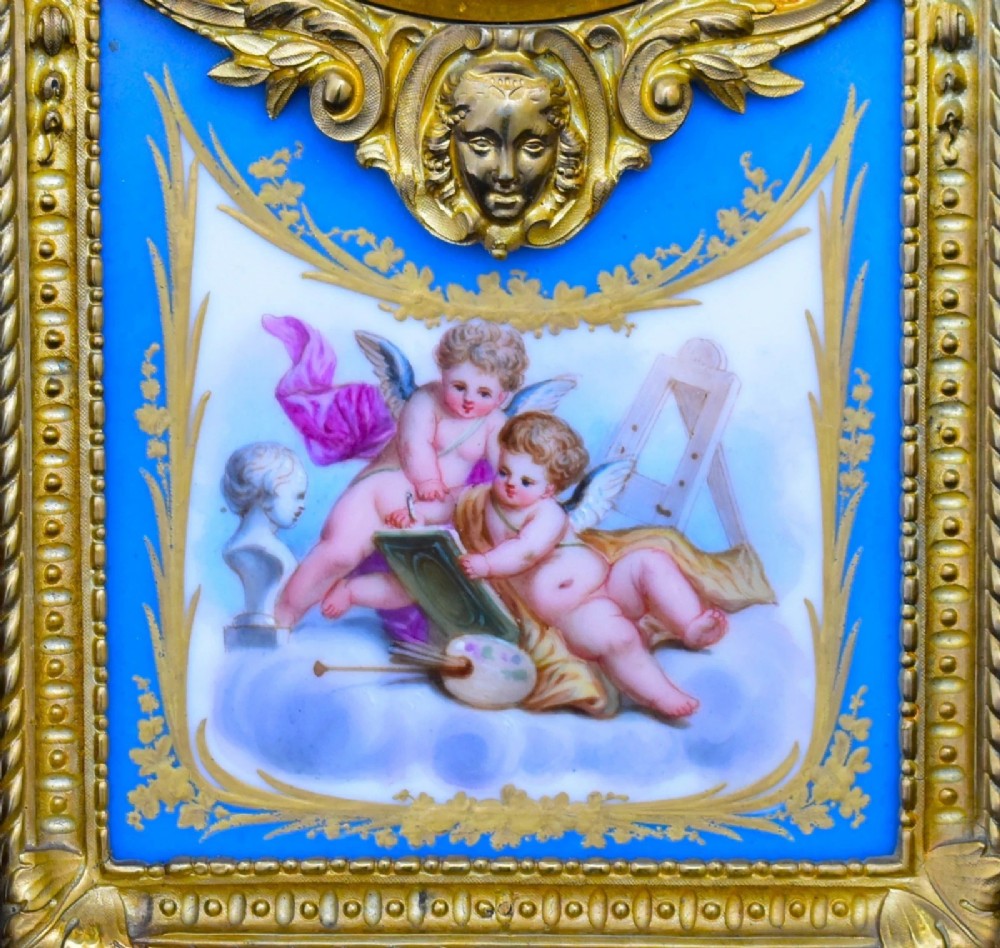 A French Napoleon III period ormolu mantel clock featuring hand-painted blue porcelain panels, classical female figures, twin fluted columns, and an enamelled dial. View VI