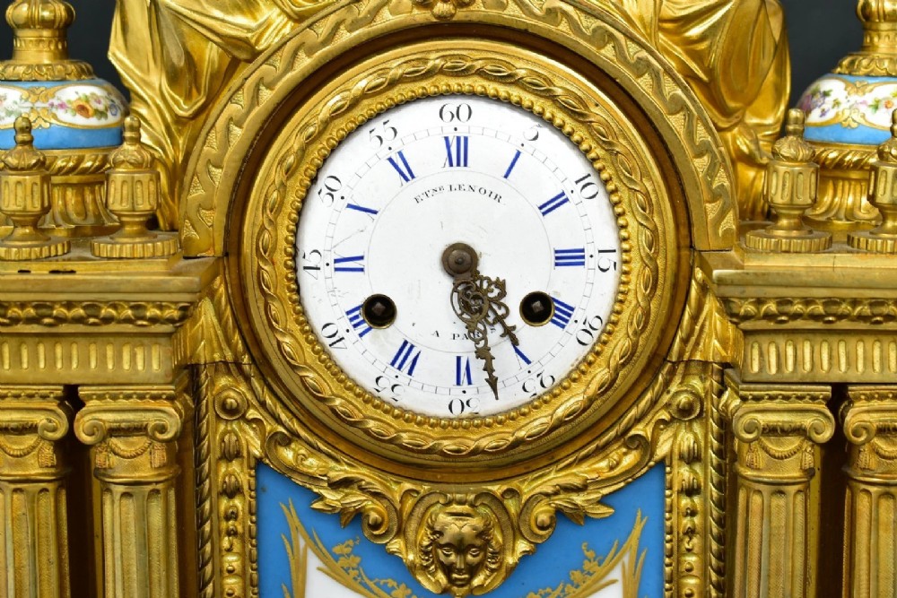 A French Napoleon III period ormolu mantel clock featuring hand-painted blue porcelain panels, classical female figures, twin fluted columns, and an enamelled dial. View VII