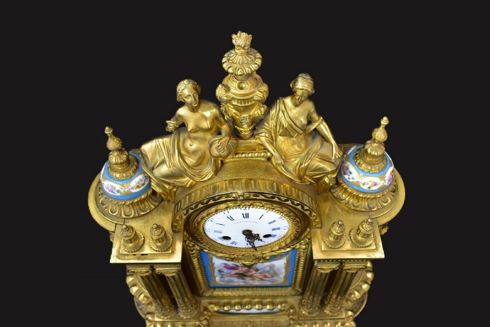 A French Napoleon III period ormolu mantel clock featuring hand-painted blue porcelain panels, classical female figures, twin fluted columns, and an enamelled dial. View VIII