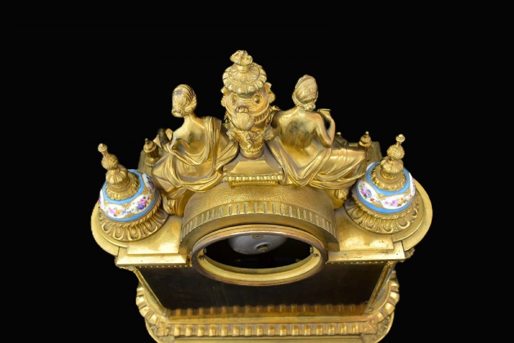 A French Napoleon III period ormolu mantel clock featuring hand-painted blue porcelain panels, classical female figures, twin fluted columns, and an enamelled dial. View IX