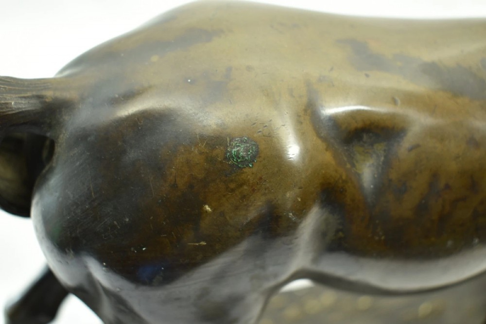 A dark brown patinated bronze sculpture of a standing horse positioned on an integral rectangular base. View IX