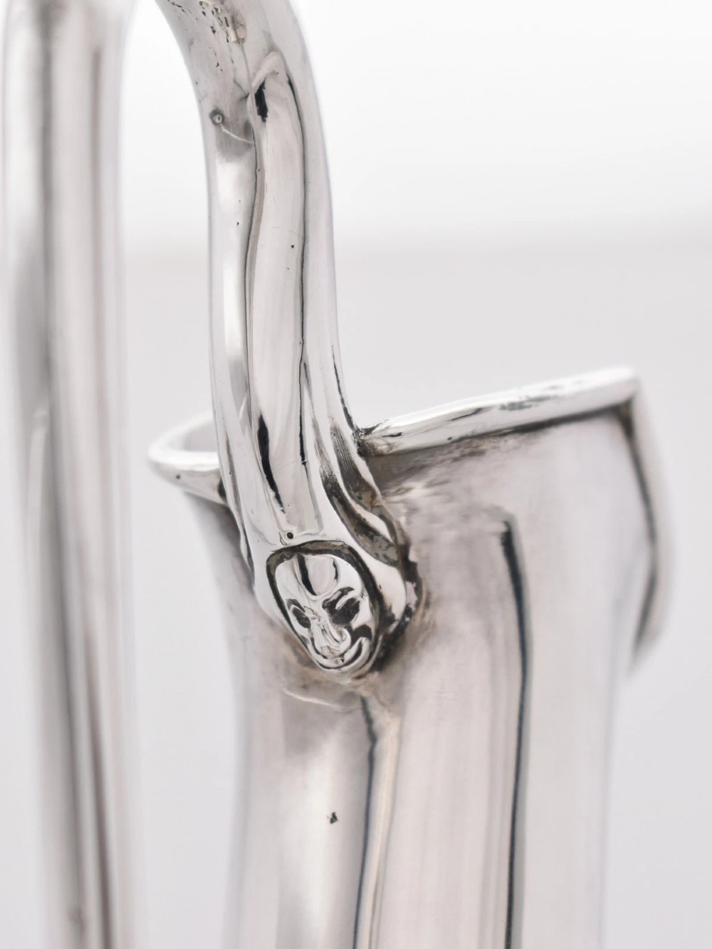 A pair of nineteenth-century clear crystal claret jugs featuring engraved silver mounts, tall necks, round stoppers, and silver handles shaped as entwined serpents. View VIII
