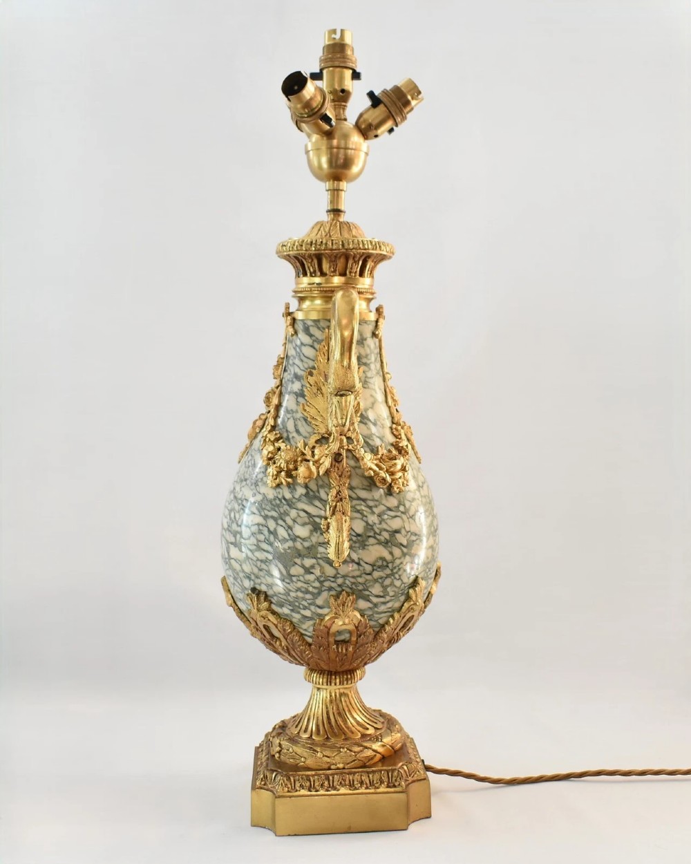 A pair of nineteenth-century French Louis XVI style cassolette table lamps crafted from green mottled marble with gilt bronze mounts and handles. View III