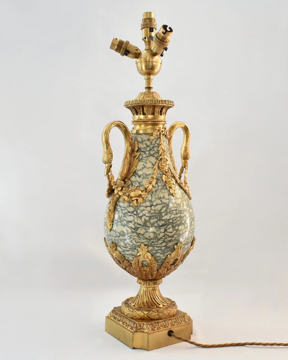 A pair of nineteenth-century French Louis XVI style cassolette table lamps crafted from green mottled marble with gilt bronze mounts and handles. View V