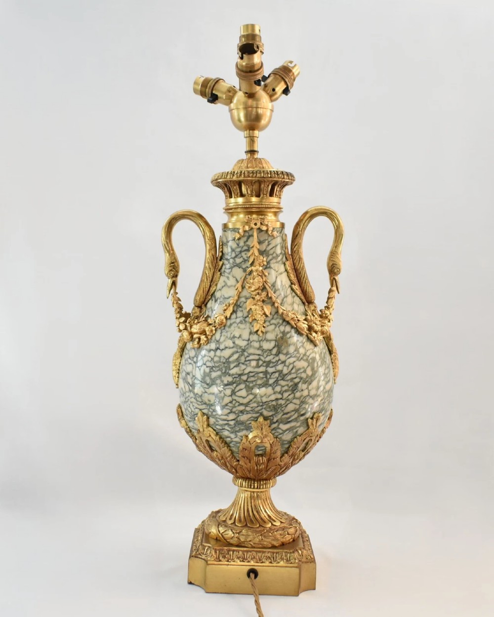 A pair of nineteenth-century French Louis XVI style cassolette table lamps crafted from green mottled marble with gilt bronze mounts and handles. View VI