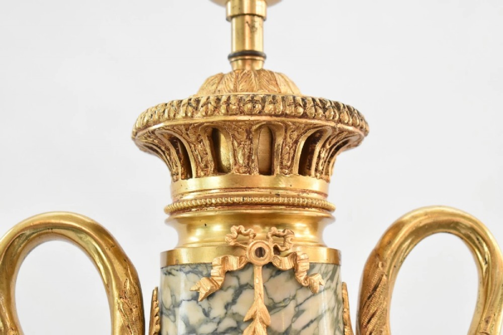 A pair of nineteenth-century French Louis XVI style cassolette table lamps crafted from green mottled marble with gilt bronze mounts and handles. View VII