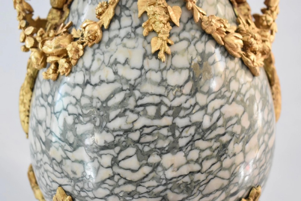A pair of nineteenth-century French Louis XVI style cassolette table lamps crafted from green mottled marble with gilt bronze mounts and handles. View VIII