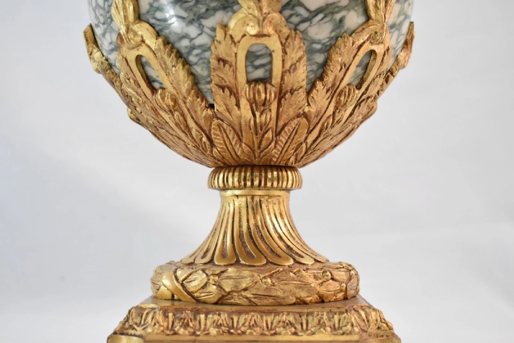 A pair of nineteenth-century French Louis XVI style cassolette table lamps crafted from green mottled marble with gilt bronze mounts and handles. View IX