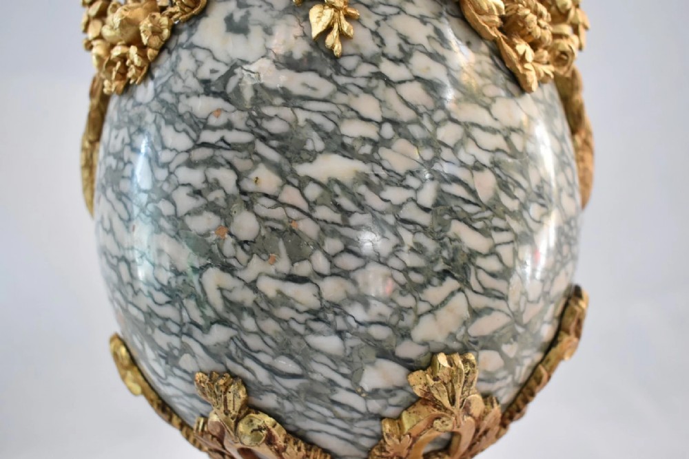 A pair of nineteenth-century French Louis XVI style cassolette table lamps crafted from green mottled marble with gilt bronze mounts and handles. View XIII