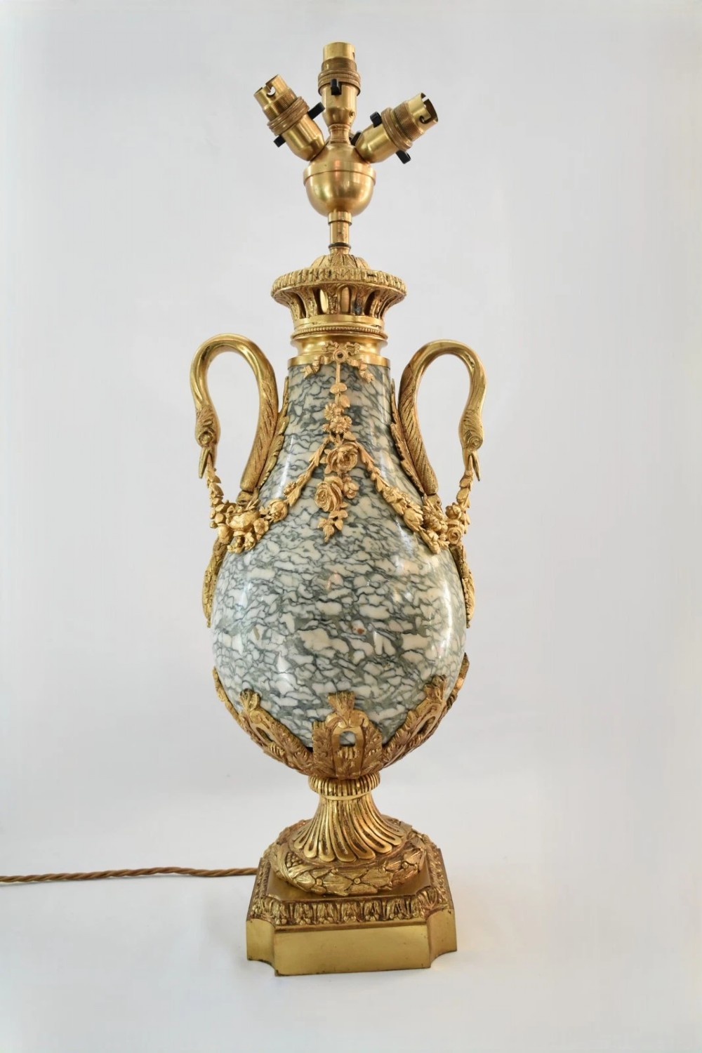 A pair of nineteenth-century French Louis XVI style cassolette table lamps crafted from green mottled marble with gilt bronze mounts and handles. View XIV