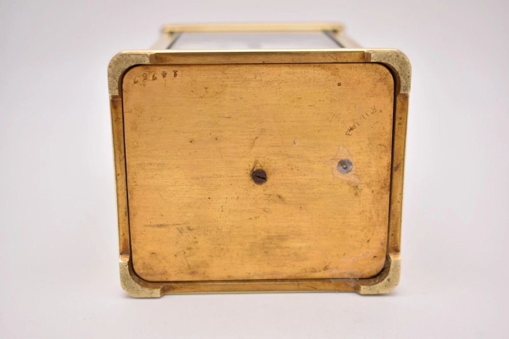A late nineteenth-century French brass gorge case carriage clock featuring a white enamel dial with Roman numerals and a hinged top carrying handle. View XI