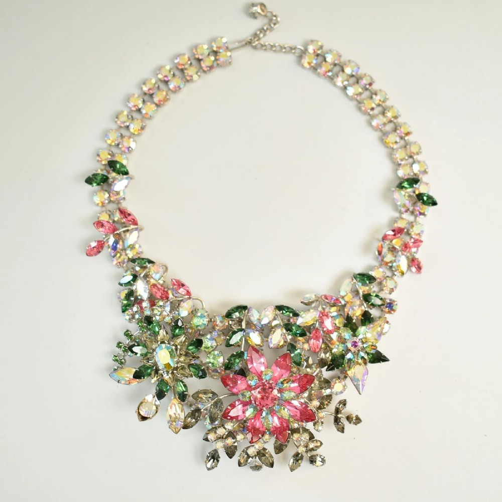 A 1950s Christian Dior costume jewellery parure set featuring a necklace, brooch, and clip-on earrings with pink, green, and aurora borealis crystal floral clusters. View II