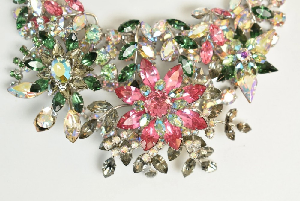 A 1950s Christian Dior costume jewellery parure set featuring a necklace, brooch, and clip-on earrings with pink, green, and aurora borealis crystal floral clusters. View III