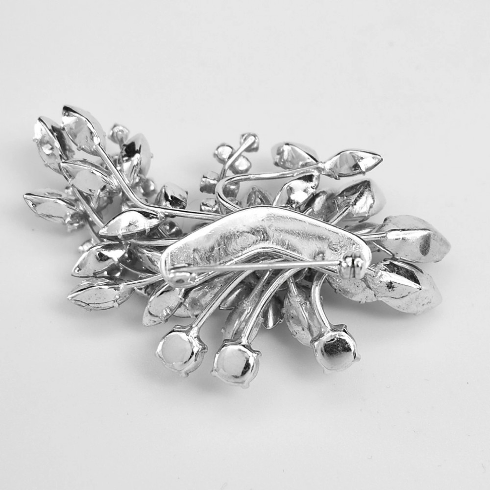 A 1950s Christian Dior costume jewellery parure set featuring a necklace, brooch, and clip-on earrings with pink, green, and aurora borealis crystal floral clusters. View VII