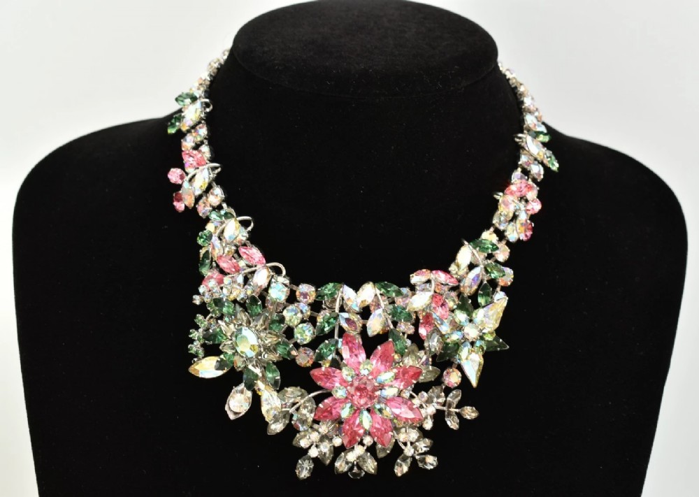A 1950s Christian Dior costume jewellery parure set featuring a necklace, brooch, and clip-on earrings with pink, green, and aurora borealis crystal floral clusters. View XIV