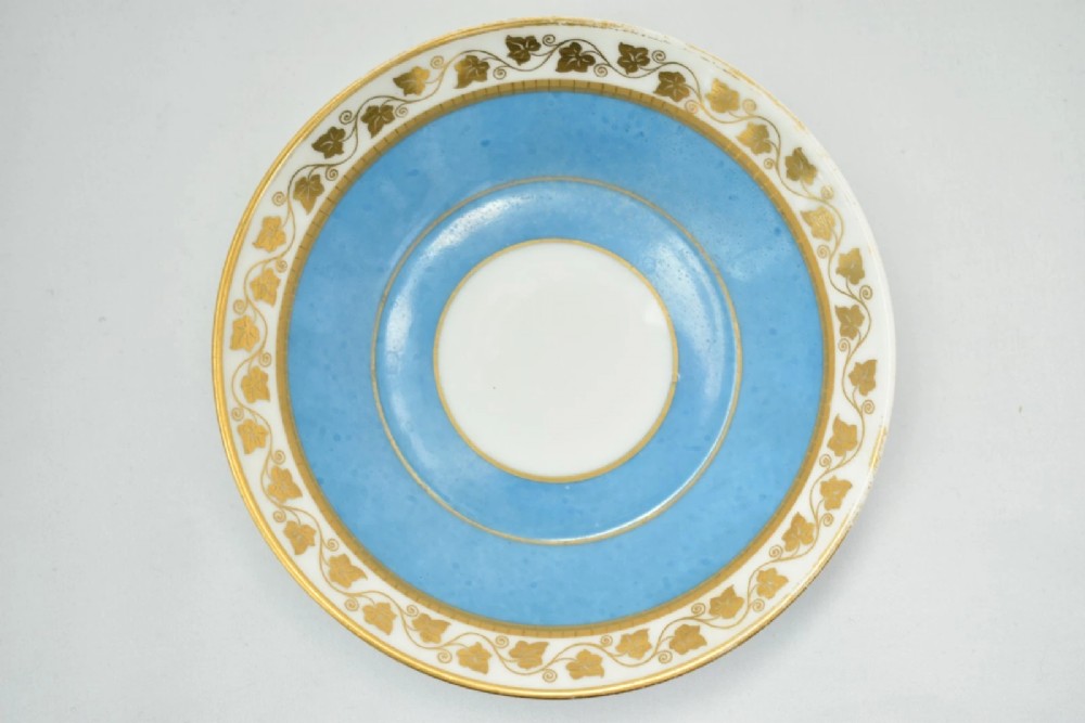 A six-piece set of white and sky-blue French porcelain demitasse cups and saucers decorated with gilded royal monograms, cherubs, and leaf borders. View XIV