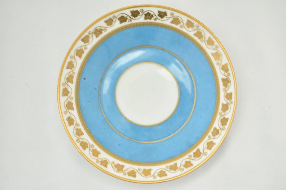 A six-piece set of white and sky-blue French porcelain demitasse cups and saucers decorated with gilded royal monograms, cherubs, and leaf borders. View XV