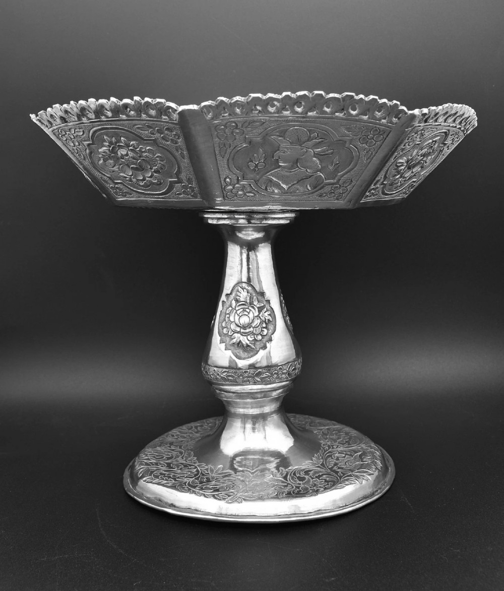 An octagonal antique silver repousse tazza featuring a central raised portrait medallion, intricate chased foliate side panels, and a pierced scalloped border. View II