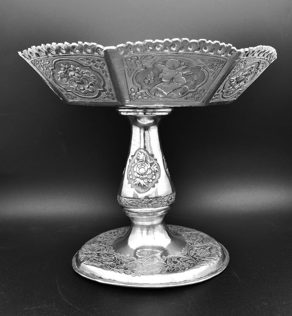 An octagonal antique silver repousse tazza featuring a central raised portrait medallion, intricate chased foliate side panels, and a pierced scalloped border. View III