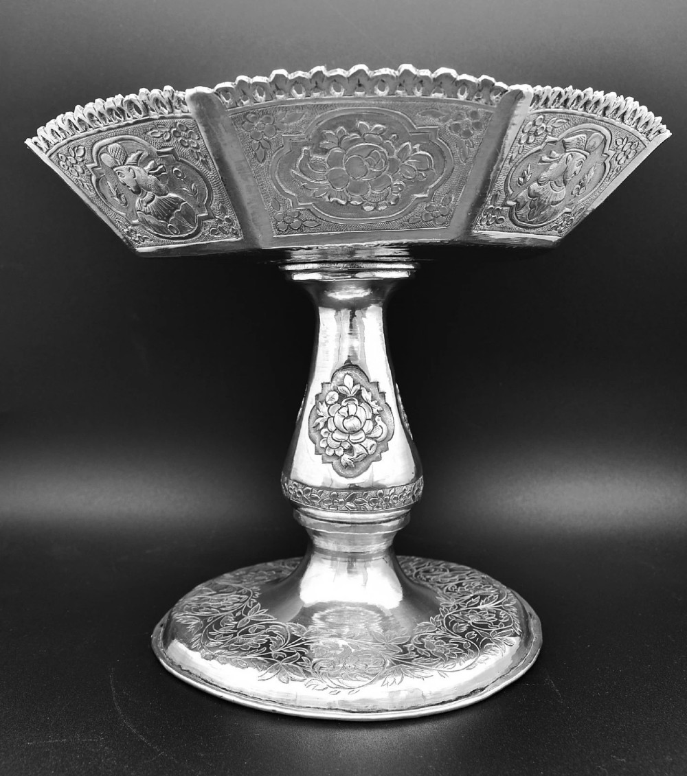 An octagonal antique silver repousse tazza featuring a central raised portrait medallion, intricate chased foliate side panels, and a pierced scalloped border. View VI