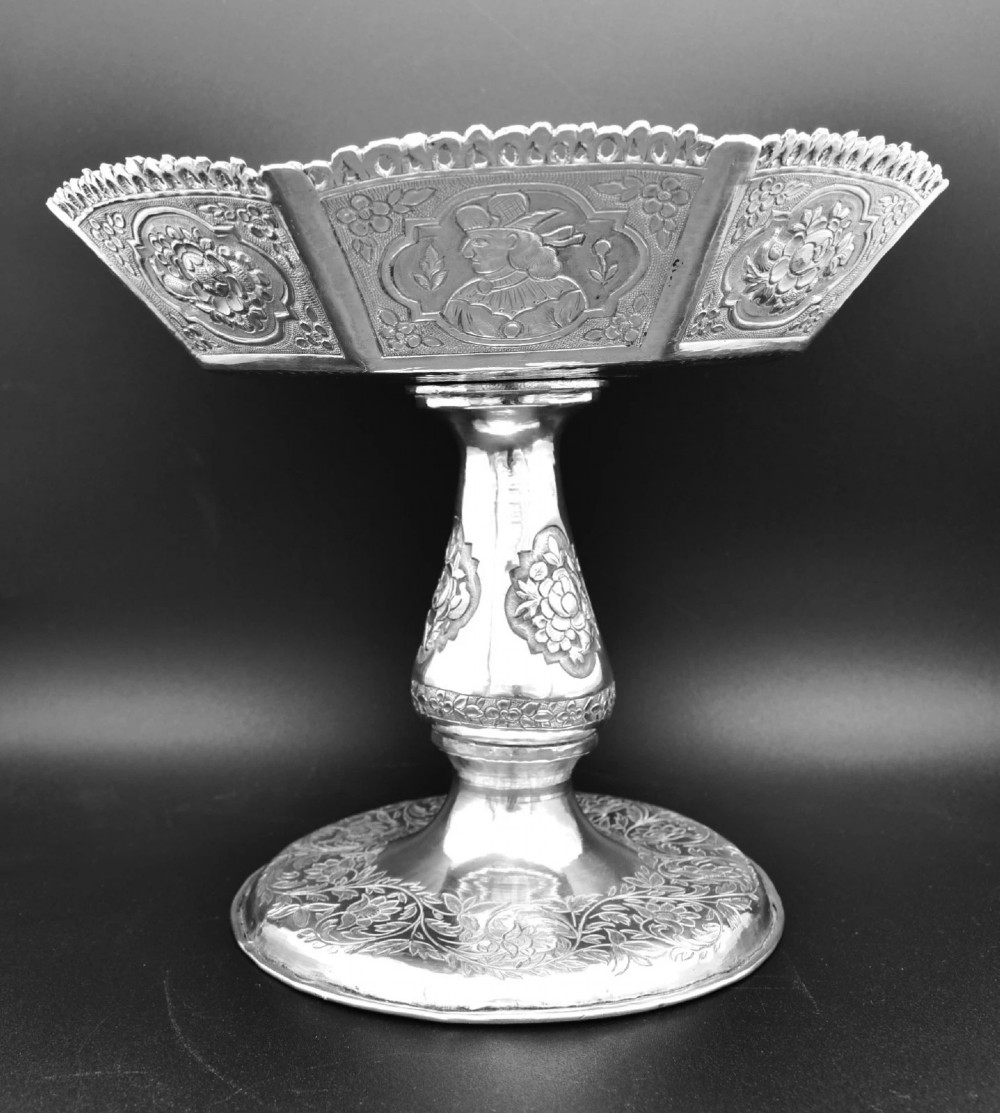 An octagonal antique silver repousse tazza featuring a central raised portrait medallion, intricate chased foliate side panels, and a pierced scalloped border. View VII