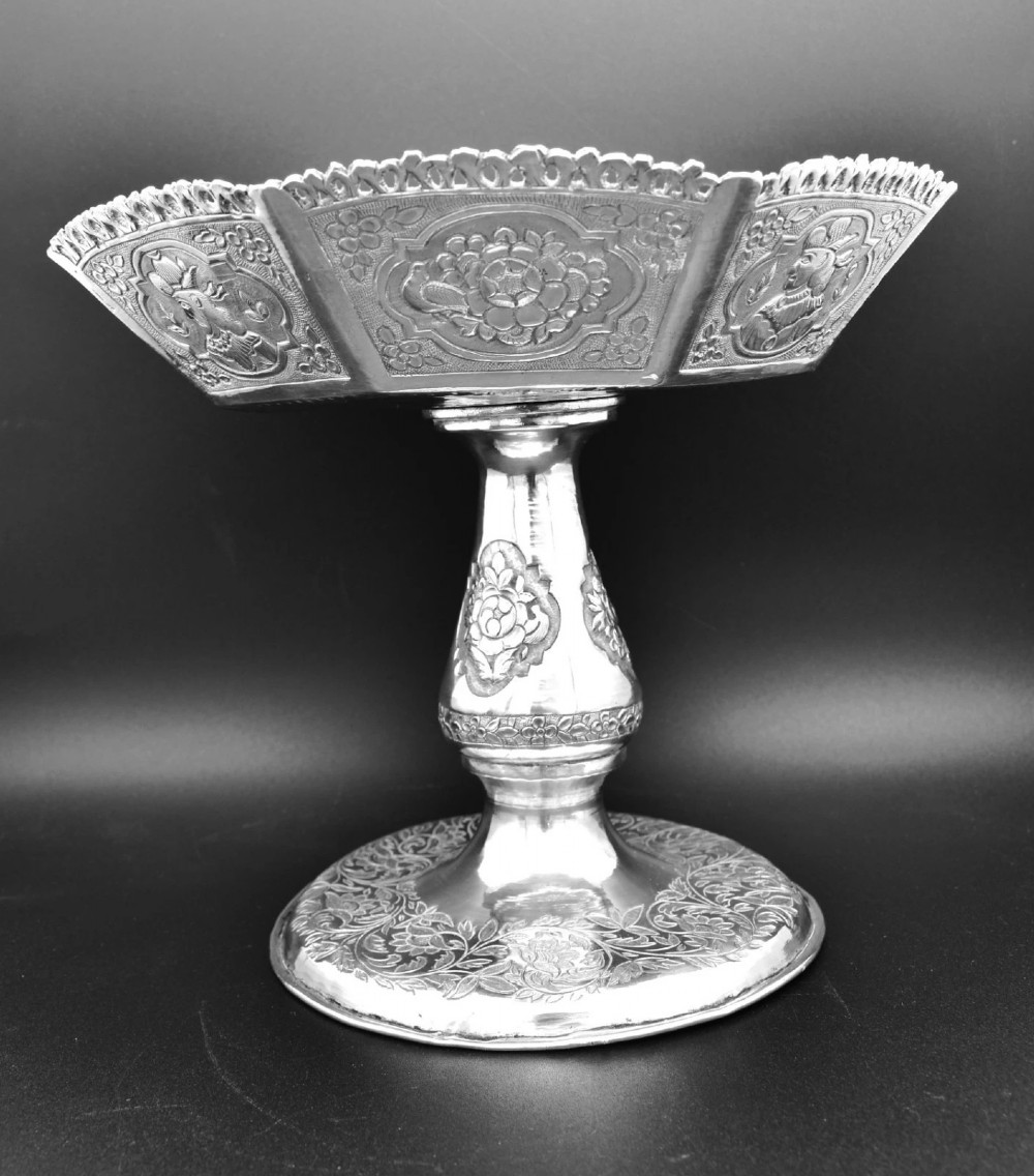 An octagonal antique silver repousse tazza featuring a central raised portrait medallion, intricate chased foliate side panels, and a pierced scalloped border. View VIII