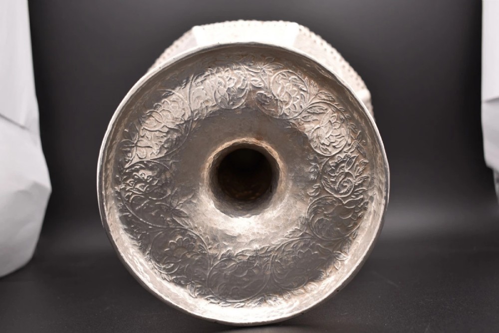 An octagonal antique silver repousse tazza featuring a central raised portrait medallion, intricate chased foliate side panels, and a pierced scalloped border. View XI