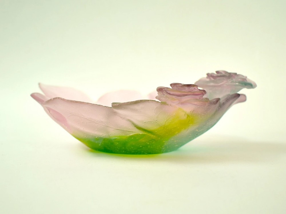 A Daum France pate de verre crystal rose bowl shaped like a pink blossom with green leaves, displayed alongside its original presentation box. View VI