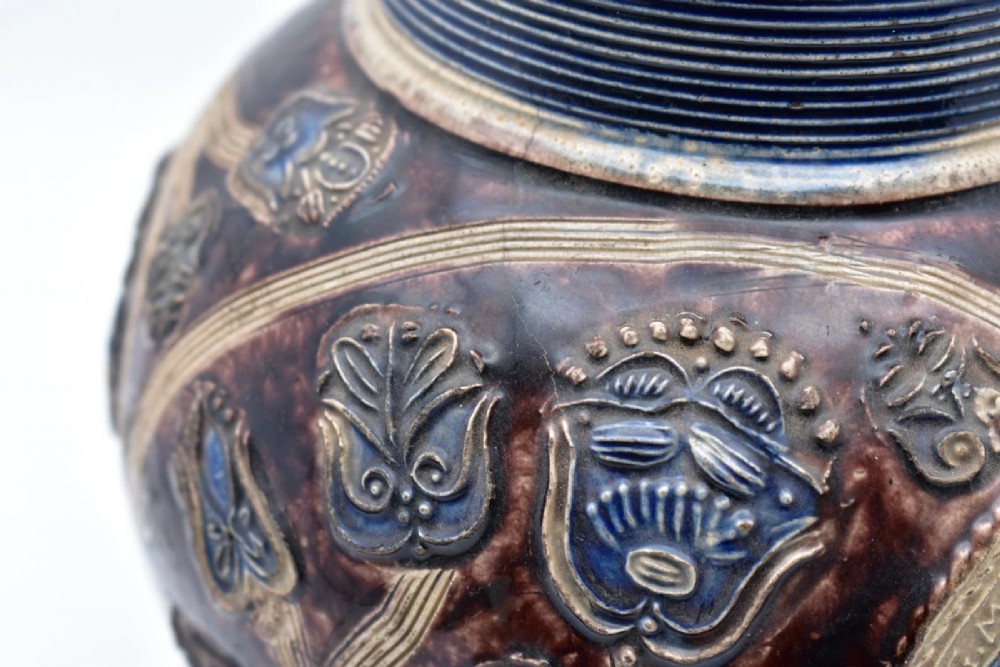 A seventeenth-century salt-glazed Westerwald stoneware jug decorated with cobalt blue and manganese violet glazes, featuring a central medallion with a royal portrait profile. View IX