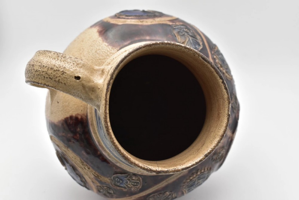 A seventeenth-century salt-glazed Westerwald stoneware jug decorated with cobalt blue and manganese violet glazes, featuring a central medallion with a royal portrait profile. View XII