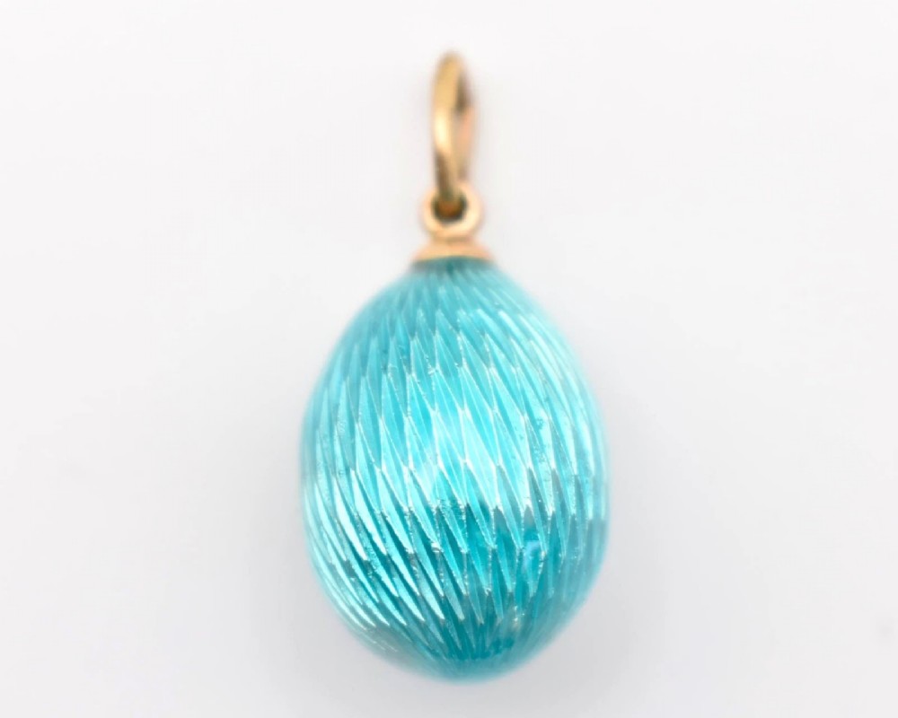 A turquoise guilloche enamel egg pendant decorated with a rose-cut diamond floral motif and topped with a gold suspension bail. View III