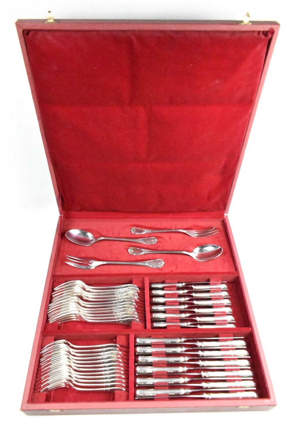A 52-piece silver-plated cutlery set arranged neatly inside a red velvet-lined presentation case.
