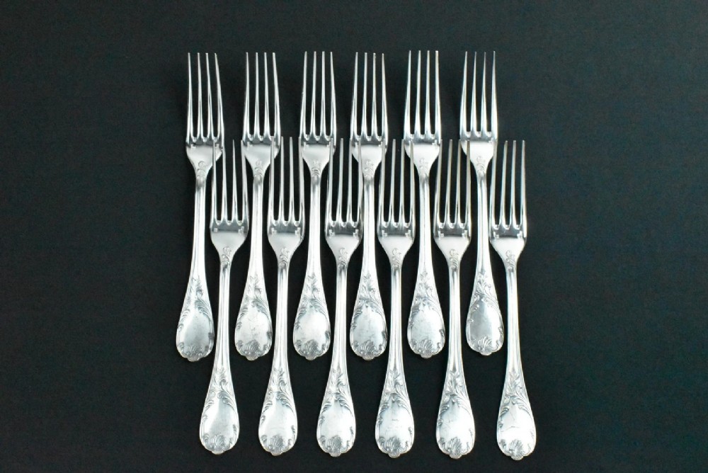 A 52-piece silver-plated cutlery set arranged neatly inside a red velvet-lined presentation case. View III