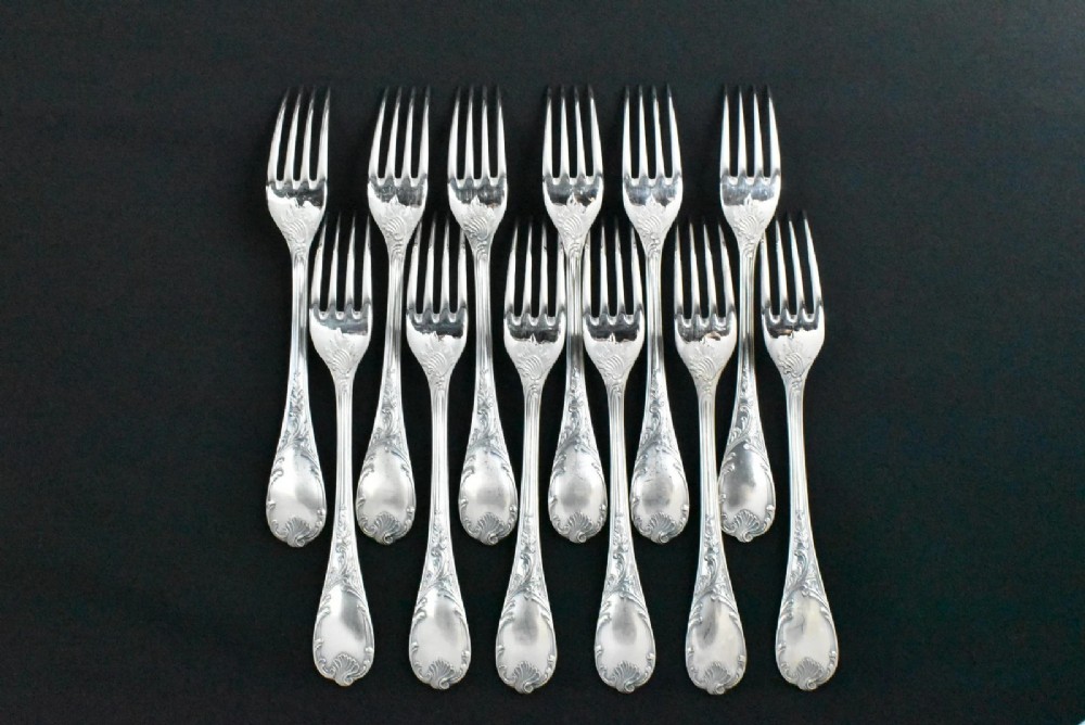 A 52-piece silver-plated cutlery set arranged neatly inside a red velvet-lined presentation case. View IV