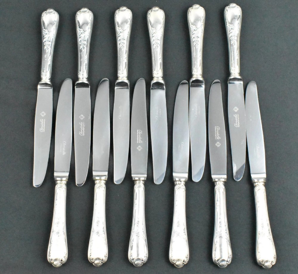 A 52-piece silver-plated cutlery set arranged neatly inside a red velvet-lined presentation case. View V