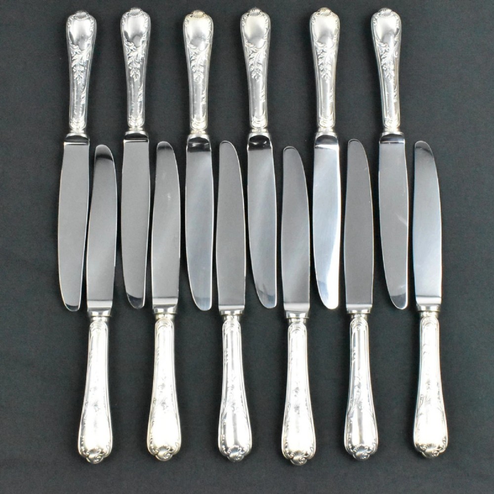 A 52-piece silver-plated cutlery set arranged neatly inside a red velvet-lined presentation case. View VI