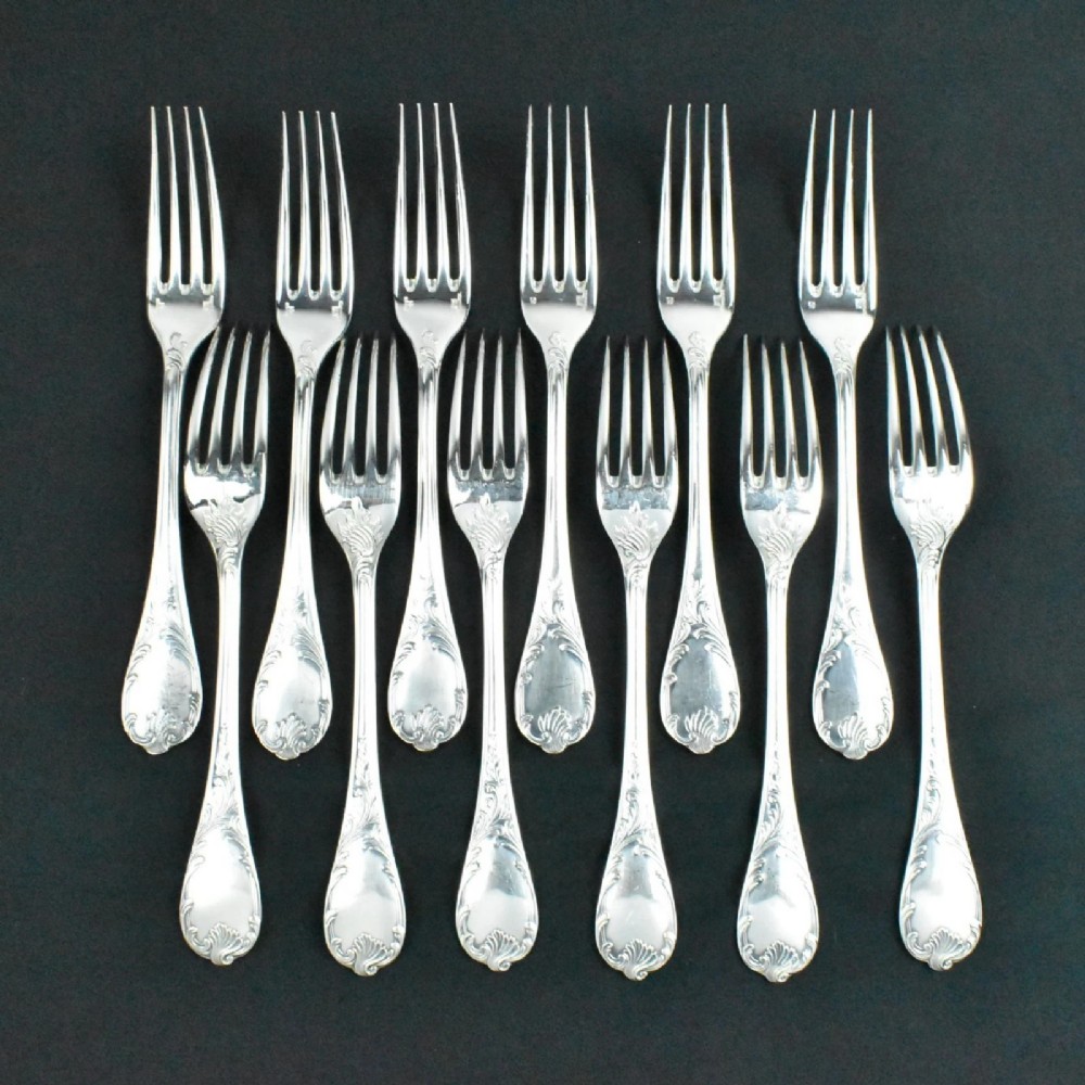 A 52-piece silver-plated cutlery set arranged neatly inside a red velvet-lined presentation case. View VII