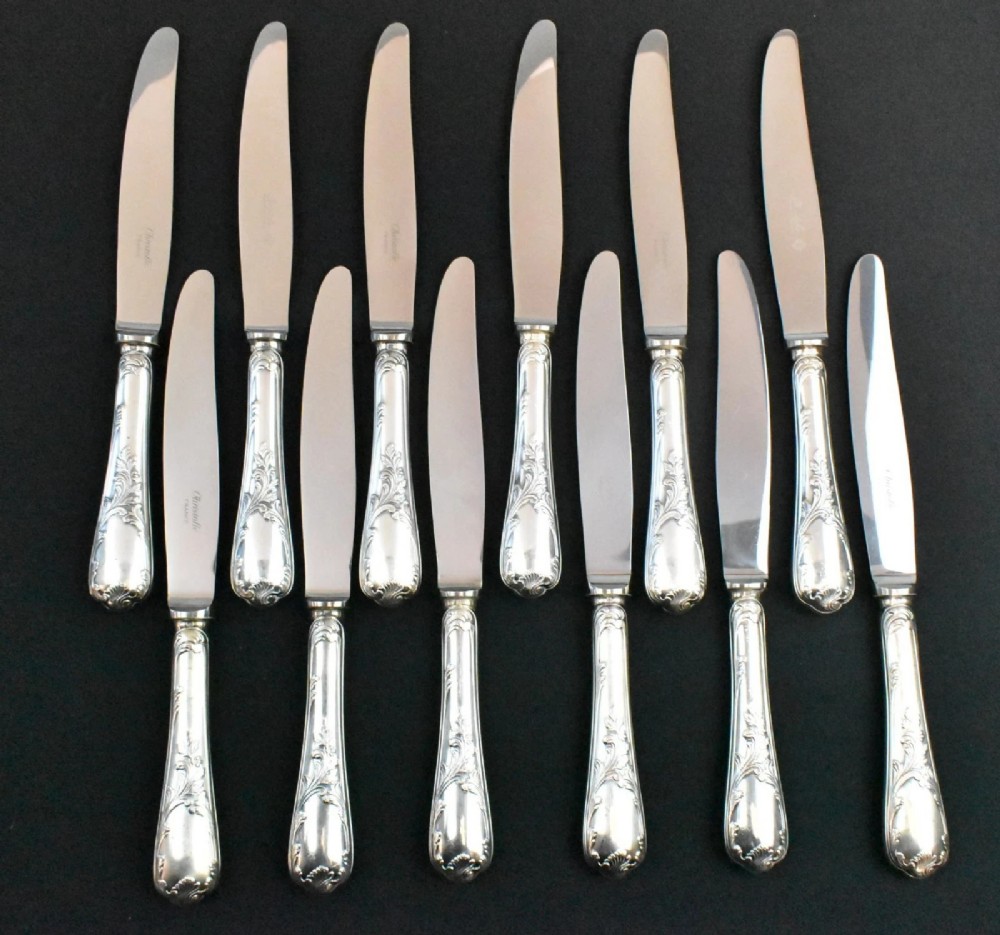 A 52-piece silver-plated cutlery set arranged neatly inside a red velvet-lined presentation case. View IX