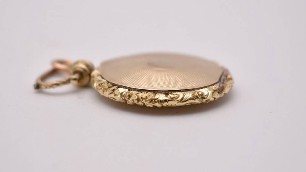 A circular gold locket pendant featuring a hand-painted portrait of a woman with dark hair against a light blue background. View VI