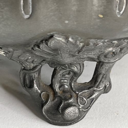 fig 1. A dark grey Victorian Britannia metal hot water pot featuring a high gooseneck spout, leaf-lobed body, scroll handle, and floral bud finial.