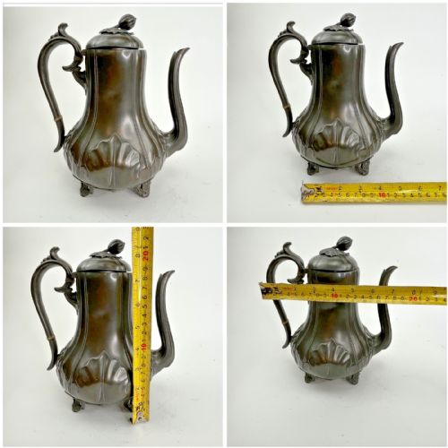 fig 4. A dark grey Victorian Britannia metal hot water pot featuring a high gooseneck spout, leaf-lobed body, scroll handle, and floral bud finial.