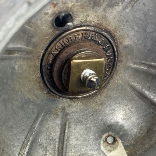 fig 7. A dark grey Victorian Britannia metal hot water pot featuring a high gooseneck spout, leaf-lobed body, scroll handle, and floral bud finial.
