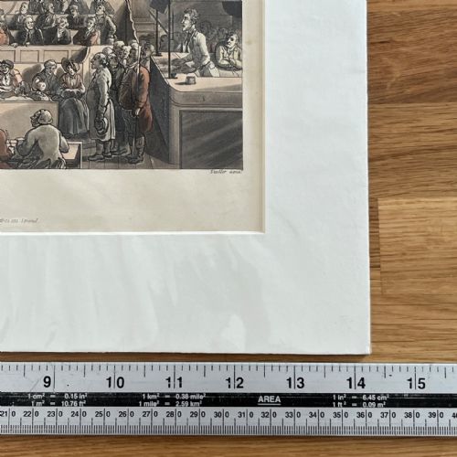 fig 6. An 1808 hand-coloured aquatint print illustrating the interior of the Old Bailey courtroom filled with figures, mounted in a white card window.