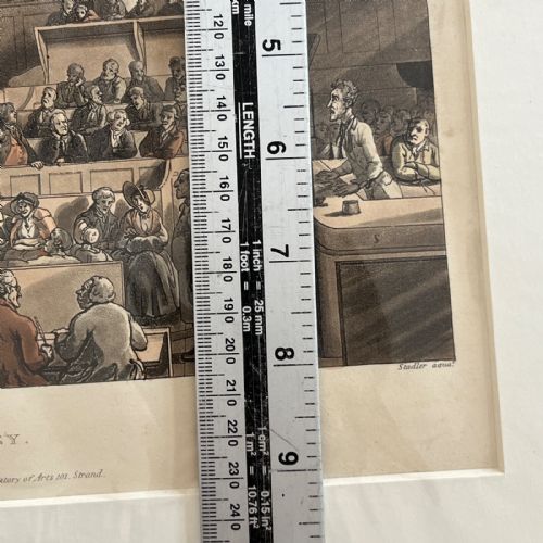 fig 9. An 1808 hand-coloured aquatint print illustrating the interior of the Old Bailey courtroom filled with figures, mounted in a white card window.