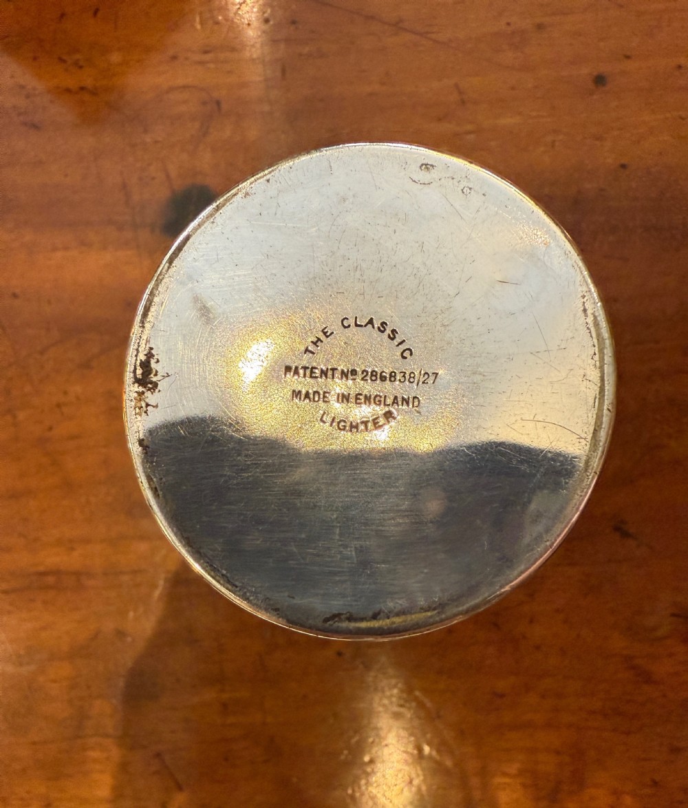 An Art Deco smoking set comprising a sage green shagreen cylindrical table lighter with silver metal fittings alongside a cream shagreen domed cigarette box resting on four small silver feet. View VI