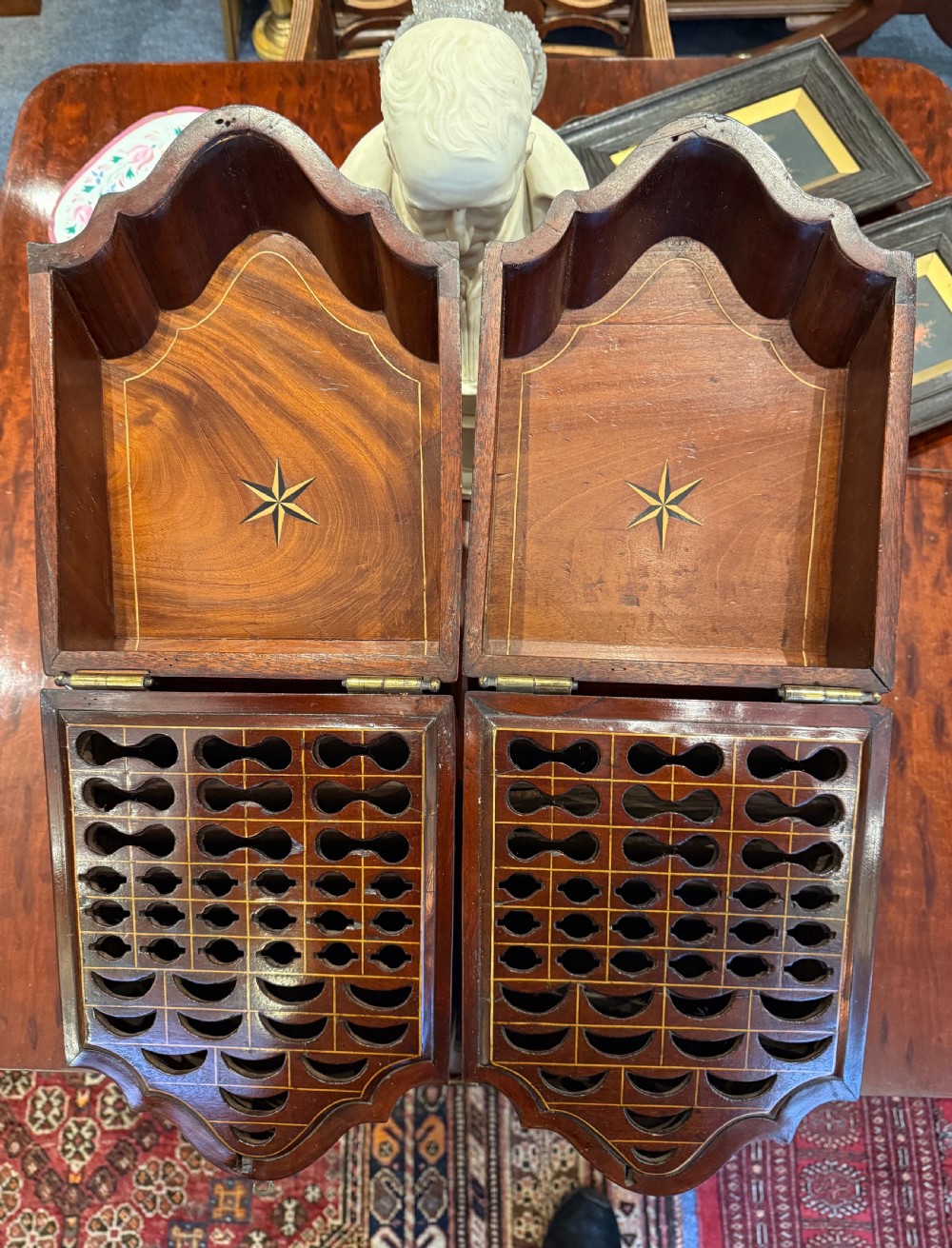 A pair of Georgian flame mahogany knife boxes featuring sloped lids, serpentine fronts, and oval patera marquetry inlays. View II