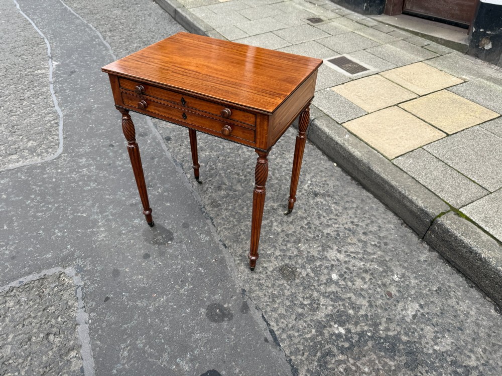 A Scottish Regency satinwood ladies work table featuring a rectangular top, two drawers with round knobs, spiral turned legs, and brass castors. View II